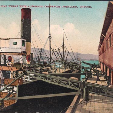 This postcard image, dating from circa 1920, shows a cargo ship being loaded with wheat at the Port of Portland.