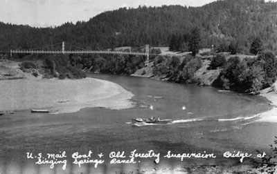 Old Agness bridge across Rogue River. "Crazy Hugo" Mayer was hit on the head with a wrench while helping build this bridge.