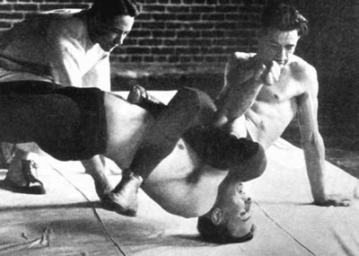 Robin Reed pinning a teammate at Oregon State (then OAC) in the 1920s.