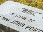 The gravestone of Ame, who despite having died 10 years after the Civil War, was still considered a slave. The gravestone of Ame, who despite having died 10 years after the Civil War, was still considered a slave.