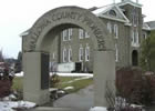 The archway monument leading up to the Wallowa County Courthouse,  built in 1936. The bronze plaque on the inside left of the arch includes  the name of murderer and horse thief Bruce “Blue” Evans. 